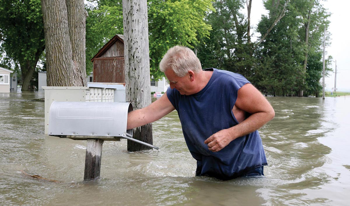 Man and mailbox in flood