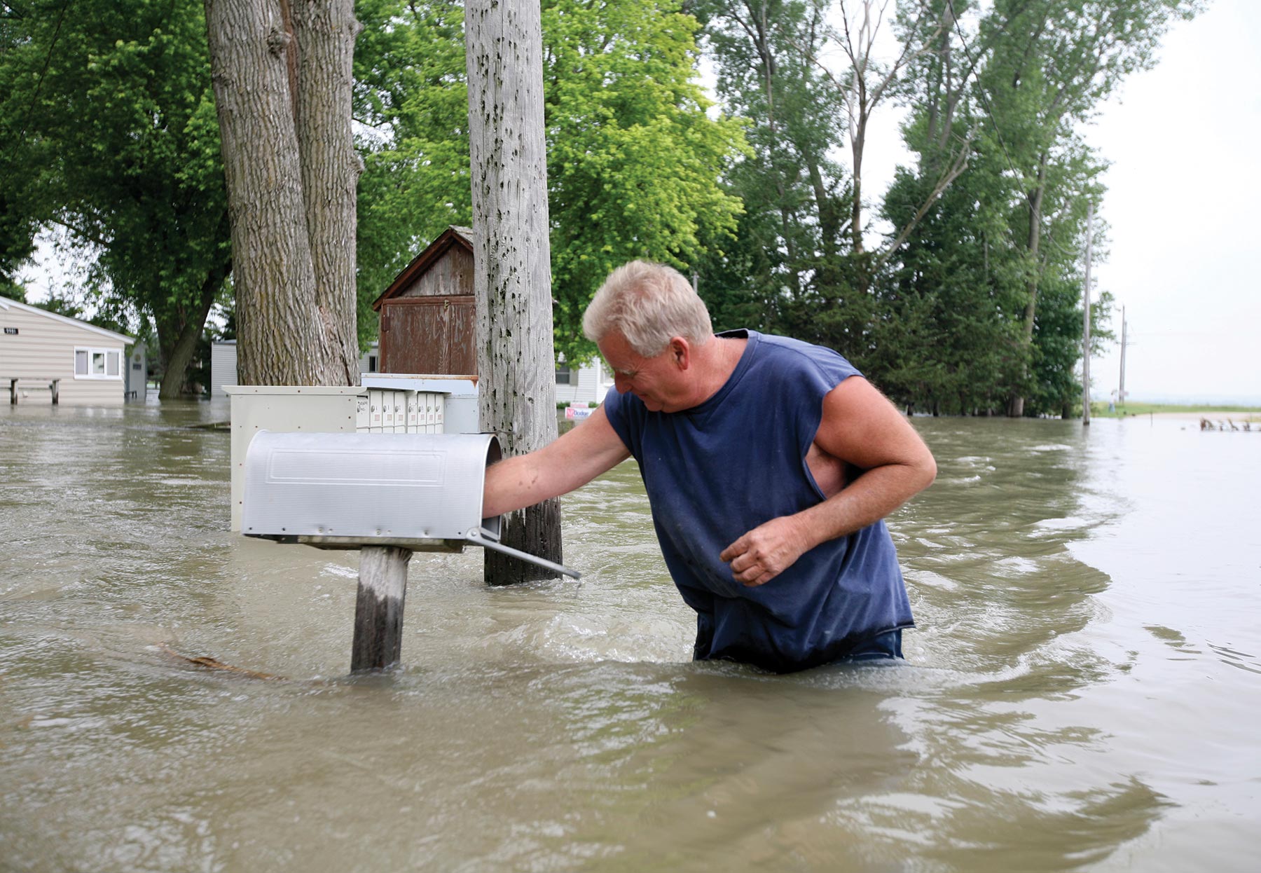 man and mailbox in flood
